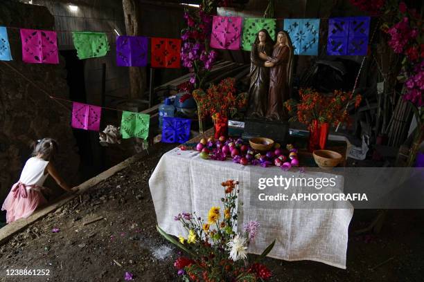 Reveler looks at an altar during the celebration of 'Fiesta de las Comadres', also known as 'Martes de Carnaval' in municipality Izalco, on March 1,...