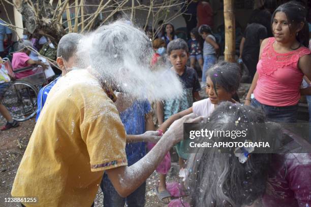 Revelers break eggs with confetti during the celebration of 'Fiesta de las Comadres', also known as 'Martes de Carnaval' in municipality Izalco, on...