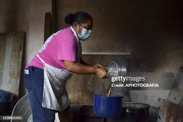 Reveler prepares coffee during the celebration of 'Fiesta de las Comadres', also known as 'Martes de Carnaval' in municipality Izalco, on March 1,...