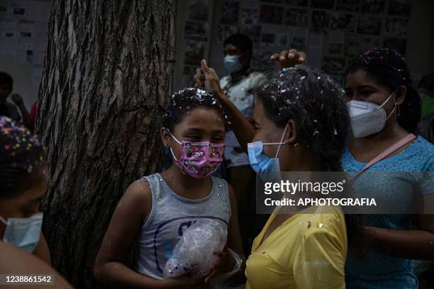 Revelers break eggs with confetti during the celebration of 'Fiesta de las Comadres', also known as 'Martes de Carnaval' in municipality Izalco, on...