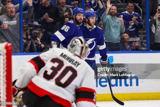 Nikita Kucherov of the Tampa Bay Lightning celebrates a goal with teammate Brayden Point against goalie Matt Murray of the Ottawa Senators during the...