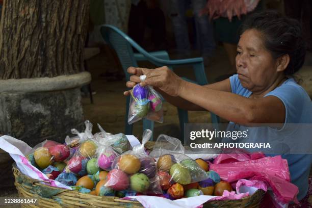 Reveler prepares eggs with confetti during the celebration of 'Fiesta de las Comadres', also known as 'Martes de Carnaval' in municipality Izalco, on...