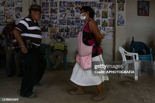 Revelers dance traditional music during the celebration of 'Fiesta de las Comadres', also known as 'Martes de Carnaval' in municipality Izalco, on...