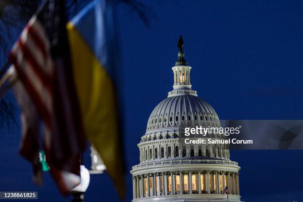 The U.S. Capitol building can be seen past American and Ukrainian flags that were hung on the light posts lining Pennsylvania Avenue ahead of U.S....