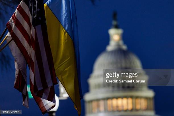 The U.S. Capitol building can be seen past American and Ukrainian flags that were hung on the light posts lining Pennsylvania Avenue ahead of U.S....