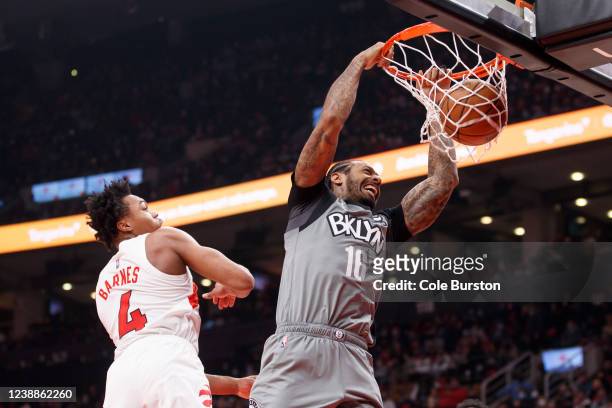 James Johnson of the Brooklyn Nets dunks over Scottie Barnes of the Toronto Raptors during the first half of their NBA game at Scotiabank Arena on...