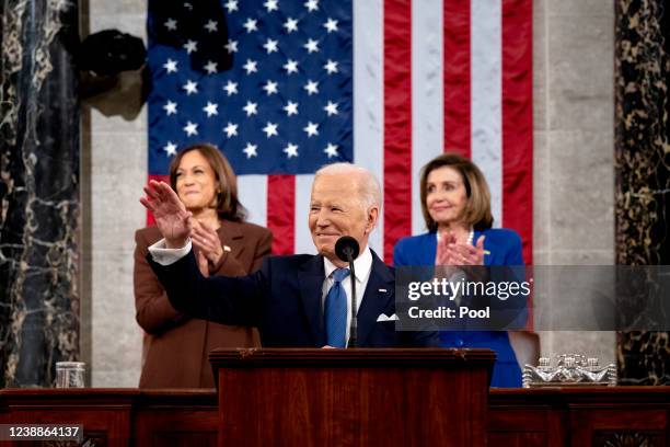 President Joe Biden waves as he delivers the State of the Union address as U.S. Vice President Kamala Harris and House Speaker Nancy Pelosi look on...