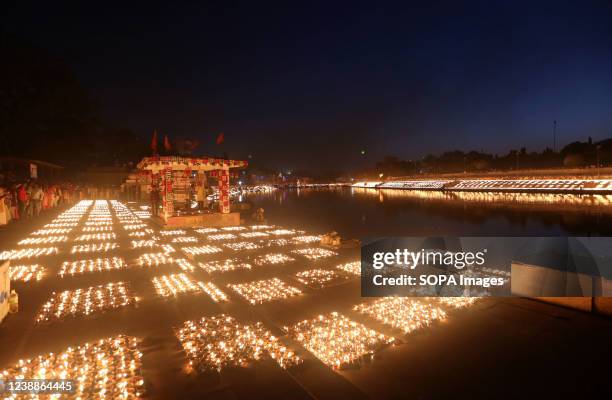 Earthen lamps lit up by the devotees at the banks of holy river Kshipra to set a new world record of lighting 2.1million lamps on the occasion of...