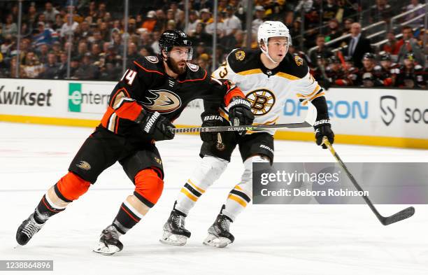 Adam Henrique of the Anaheim Ducks battles for position against Charlie McAvoy of the Boston Bruins during the game at Honda Center on March 1, 2022...