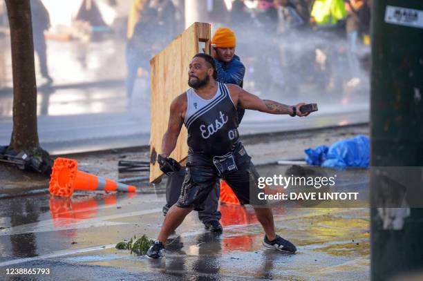 People face off with police near Parliament as police move in to clear protesters in Wellington on March 2 during demonstrations against Covid-19...