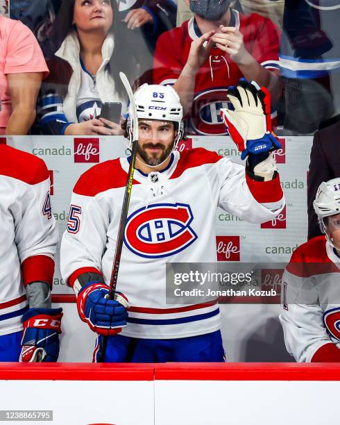 Mathieu Perreault of the Montreal Canadiens acknowledges the fans following a video montage during a first period stoppage in play against the...