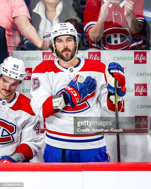 Mathieu Perreault of the Montreal Canadiens acknowledges the fans following a video montage during a first period stoppage in play against the...