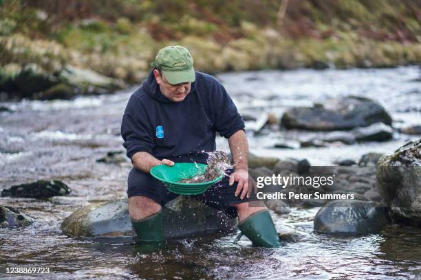 David Armstrong-Reed, a hobby gold panner, is seen searching for gold on March 1, 2022 in Brechin, Scotland. Gold exploration in Scotland has boomed...