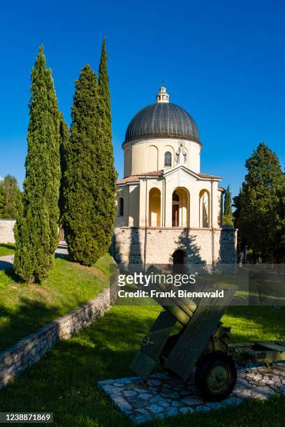 The church of Madonna delle Grazie, located in the cemetery of the village of Cison di Valmarino, surrounded by cypresses and trees.