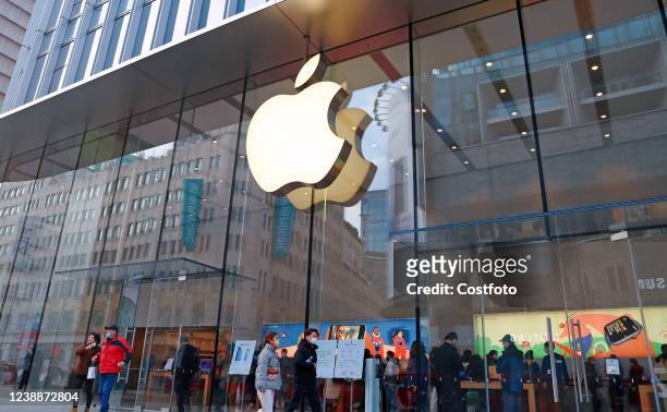 Customers shop at apple's flagship store for smart products on Nanjing Road pedestrian street in Shanghai, China, Feb. 23, 2022. Apple will unveil a...