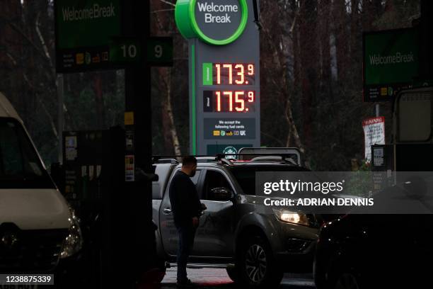Motorists queue for petrol and diesel fuel at a petrol station off of the M3 motorway near Fleet, southwest of London, on March 2, 2022. - Oil prices...