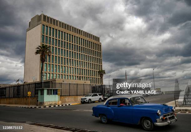 An old American car drives past the US Embassy in Havana, on March 2, 2022.