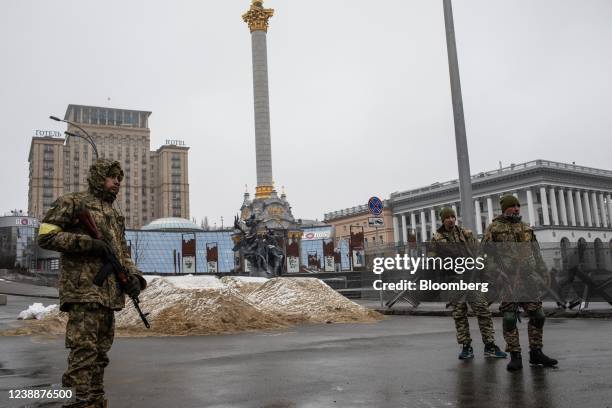 Members of Ukraine's Territorial Defense stand guard next to sand berms at Independence Square in Kyiv, Ukraine, on Wednesday, March 2, 2022. Russia...