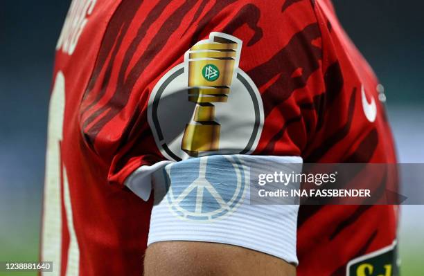 Freiburg's German forward Kevin Schade wears a captain's armband with a peace sign during the German Cup quarter-final football match Bochum v...