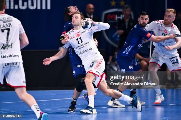 Lukas SANDELL of Aalborg and Julien BOS of Montpellier during the EHF Champions League between Montpellier and Aalborg on March 2, 2022 in...