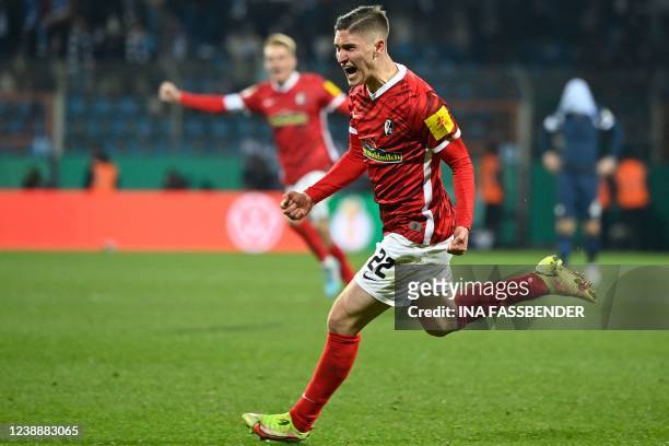 Freiburg's Hungarian midfielder Roland Sallai celebrates scoring at the end of extra time during the German Cup quarter-final football match VfL...