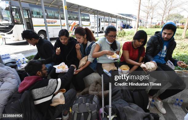 Students from Kerala eating food after returning from war ravaged Ukraine at Indira Gandhi International airport on March 2,2022 in New Delhi, India.