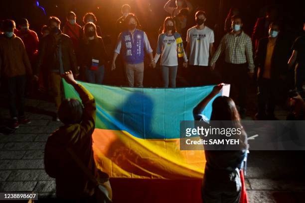 Group of Slavic people including Ukrainians and Russians, living in Taiwan join their hands to pray for the peace amid Russia's invasion of Ukraine,...