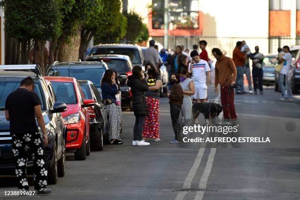 People remain outside their houses after a quake in Mexico City, on March 3, 2022. 2-magnitude earthquake hit eastern Mexico on Thursday,...