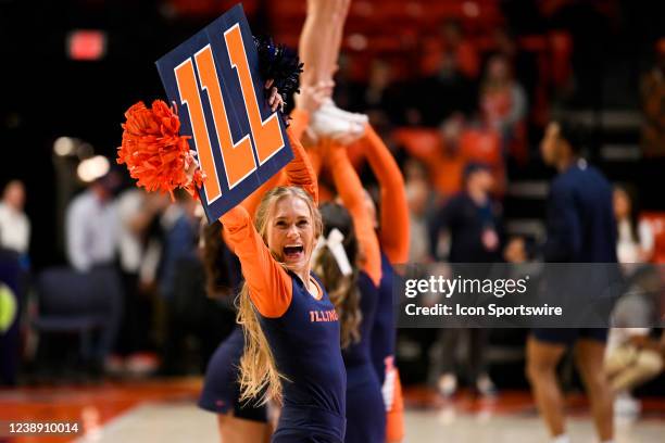 University of Illinois cheerleader holds a sign during a college basketball game between the Penn State Nittany Lions and the Illinois Fighting...