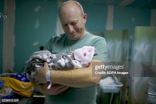 Father holds his new born baby in the bomb shelter of a maternity hospital. Russia said it would press forward with its invasion of Ukraine until its...