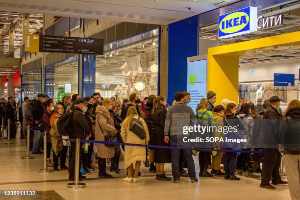 People line up at the entrance to IKEA Rostokino in Moscow after the Swedish company announced plans to temporarily close its shops in Russia. The...