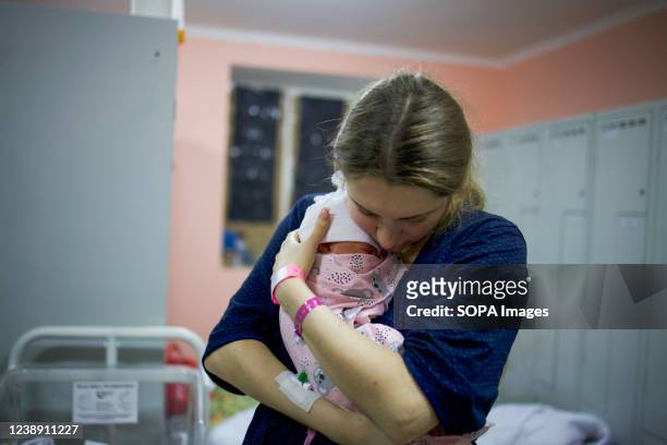 Mother holds her new born baby in the bomb shelter of a maternity hospital. Russia said it would press forward with its invasion of Ukraine until its...