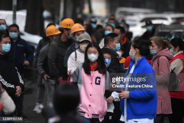 Residents line up for the mandatory Covid-19 test in a residential block in Wuhan in central China's Hubei province Friday, March 04, 2022. The city...