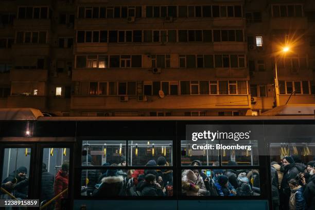 Displaced Ukrainians wait on a bus taking them to temporary housing after travelling by train from Iasi, a Romanian city near the Moldovan border, at...