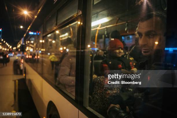 Displaced Ukrainians wait on a bus taking them to temporary housing after travelling by train from Iasi, a Romanian city near the Moldovan border, at...