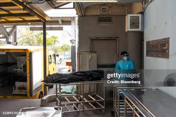 Image depicts death.) A worker wearing personal protective equipment transfer the body of a deceased person at the Fu Shan Public Mortuary in Hong...