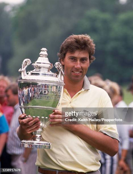 Mike Harwood of Australia celebrates with the trophy after winning the Volvo British PGA Championship at the Wentworth Club on May 28, 1990 in...