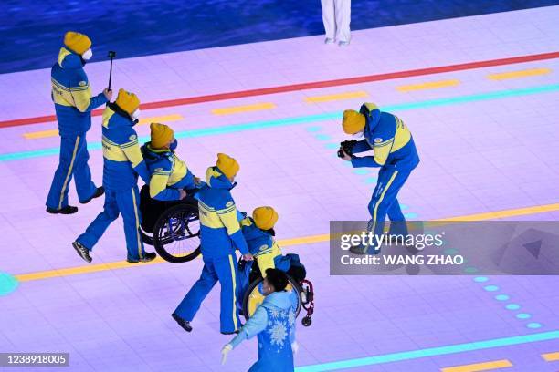 Athletes from Ukraine take part in the opening ceremony of the Beijing 2022 Winter Paralympic Games at the National Stadium in Beijing on March 4,...