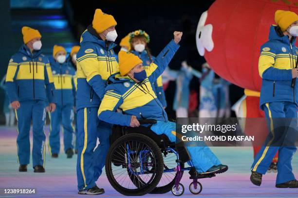 Athletes from Ukraine take part in the opening ceremony of the Beijing 2022 Winter Paralympic Games at the National Stadium in Beijing on March 4,...