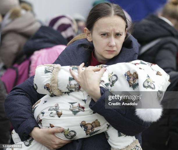 Ukrainian civilians arriving in Poland, wait to go Warsaw by bus at the assembly center near the Korczowa border crossing on the Ukrainian border, in...