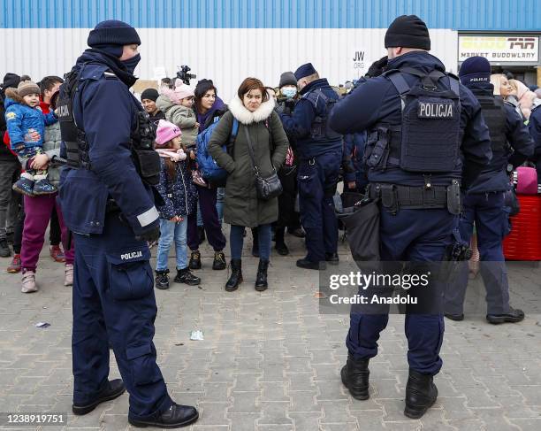 Ukrainian civilians arriving in Poland, wait to go Warsaw by bus at the assembly center near the Korczowa border crossing on the Ukrainian border, in...