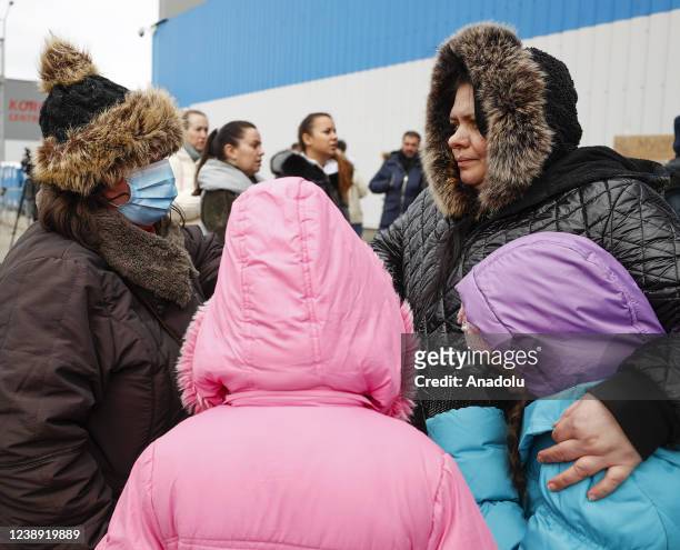 Ukrainian civilians arriving in Poland, wait to go Warsaw by bus at the assembly center near the Korczowa border crossing on the Ukrainian border, in...