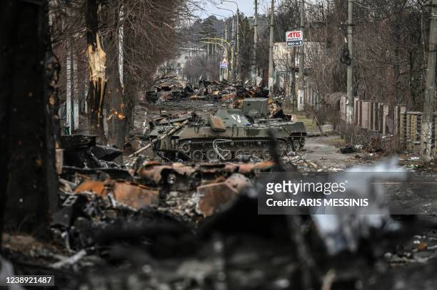 Destroyed Russian armored vehicles line the street in the city of Bucha, west of Kyiv, on March 4, 2022. - The UN Human Rights Council on March 4...