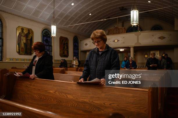 Worshippers attend a service the St. John the Baptist Ukrainian Catholic Church in Maizeville, Pennsylvania, on March 2, 2022. - In America's...