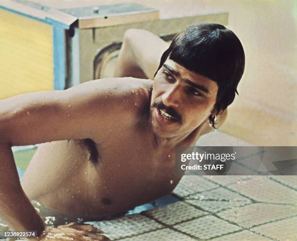 American swimmer Mark Spitz gets out of the pool after winning the gold medal in the 100m butterfly in front of Canadian Bruce Robertson and...