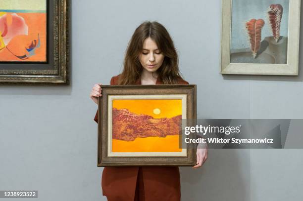 Staff member holds 'But in Color' by Max Ernst , estimate: £180,000-250,000 during a photo call for The Minds Eye: Surrealist Sale at Bonhams auction...