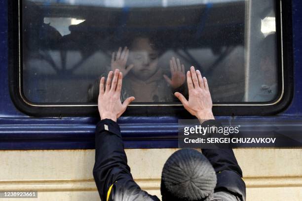 Man gestures in front of an evacuation train at Kyiv central train station on March 4, 2022. - Ukraine accused the Kremlin of "nuclear terror" on...