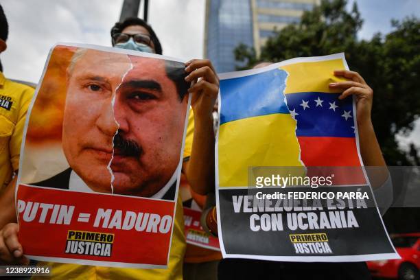 An activist member of opposition party Primero Justicia holds a placard showing the face of Russian President Vladimir Putin and Venezuelan President...