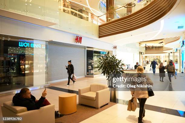 Shoppers go past closed H&M store in Vegas shopping mall on March 4, 2022 in Moscow, Russia. Swedish fashion group H&M is temporarily pausing all...