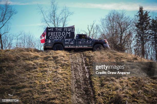 Pickup truck sits atop a hill at the Hagerstown Speedway as people gather and await the arrival of the Peoples Convoy of truckers on March 4, 2022 in...